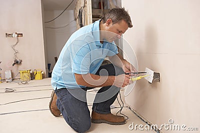 Electrician Installing Wall Socket Stock Photo