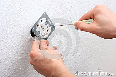 Electrician installing wall socket Stock Photo