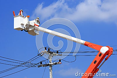 Electrician lineman on hydraulic platform Stock Photo
