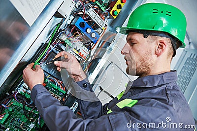 Electrician make maintenance in engine room of elevator Stock Photo