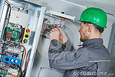 Electrician make maintenance in engine room of elevator Stock Photo