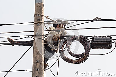 Electrician man work on electric pole. Editorial Stock Photo