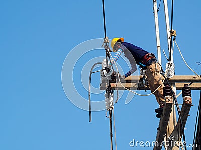 Electrician man working at height and dangerous ,high voltage power line Editorial Stock Photo