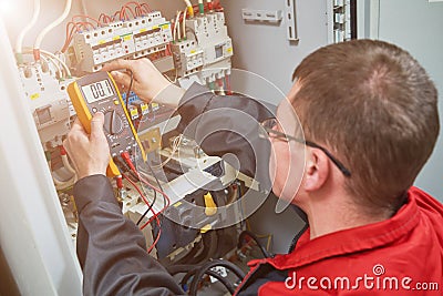 Electrician measurements with multimeter tester Stock Photo