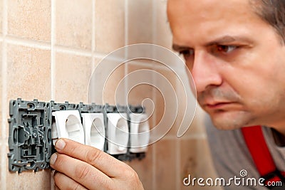Electrician mounting the electrical wall fixture or plug components Stock Photo