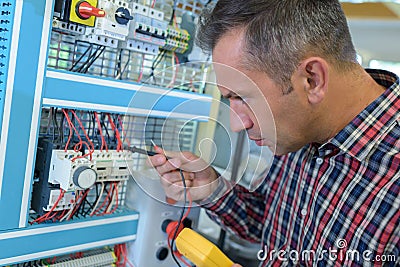 electrician near low-voltage cabinet Stock Photo