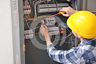 Electrician repairing distribution board Stock Photo