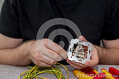 Electrician repairing a socket Stock Photo