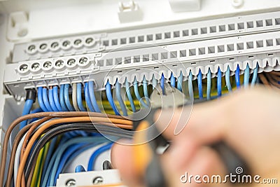 Electrician repairing faulty wiring Stock Photo