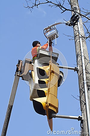 Electrician repairing traffic light Editorial Stock Photo