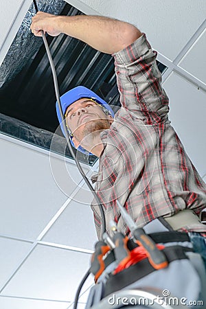 Electrician repairing wiring in an office Stock Photo