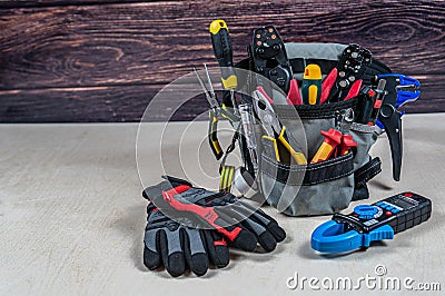 Electrician`s bag with a professional electric tools, gloves, multimeter Stock Photo