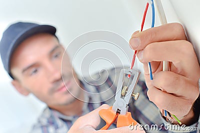 Electrician snipping a wire Stock Photo