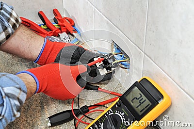 Electrician technician working safely on a residential electrical system. Stock Photo