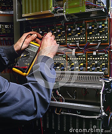 Electrician testing industrial machine Stock Photo