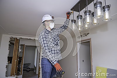 Electrician testing new lighting Stock Photo