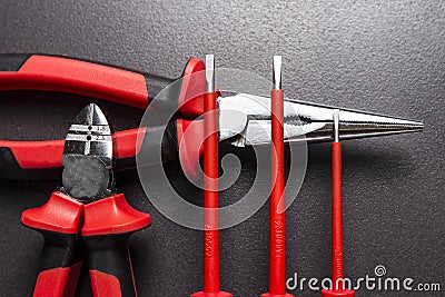 Electrician tools on black background. Screwdrivers, cutters and platypuses on black background. Stock Photo