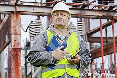 Electrician using tablet PC and take substation technical inspection Stock Photo