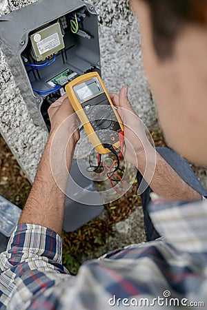 Electrician using voltmeter device Stock Photo