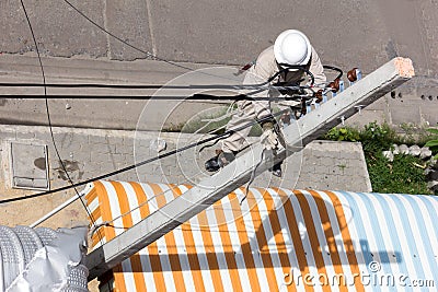 Electrician wiring on a electric pole Editorial Stock Photo