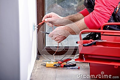 Electrician at work, home renovation, electrical installation, Hand of an electrician, handyman at work Stock Photo