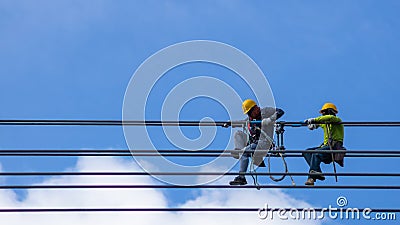 Electrician work installation of high voltage cable in high voltage safely and systematically over and blue sky background Stock Photo