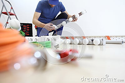 Electrician at work installing lamp, with bulb, install electric circuits, electrical wiring Stock Photo