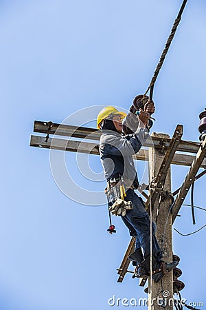 Electrician working on the electricity pole Editorial Stock Photo