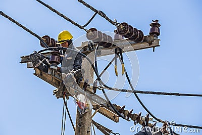 Electrician working on the electricity pole Editorial Stock Photo