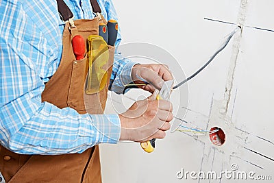 Electricians at cable wiring work Stock Photo