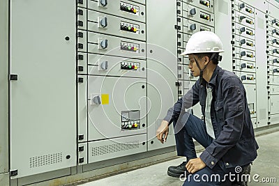 Electricians are checking electrical control panels in industrial plants Stock Photo