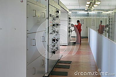 Electricians inspecting equipment in the switchboard room. Editorial Stock Photo