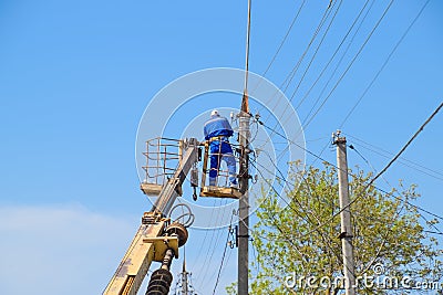 Electricians repair the power line. Workers are locksmith electricians. Editorial Stock Photo