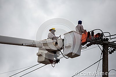 electricians repairing wire of the power line on electric power Stock Photo