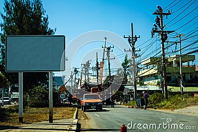 Electricians working on a power pole, filled with complex communication lines. copy space Stock Photo