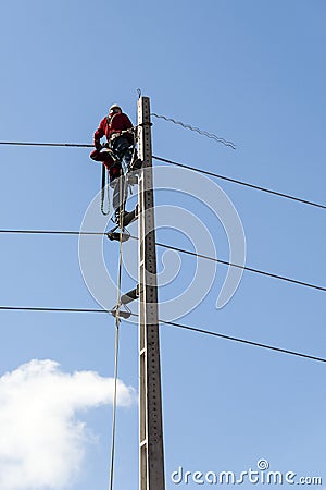 Electricians working on a pylon Stock Photo