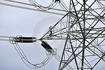 Electricity board employee working in a high voltage electric post Editorial Stock Photo