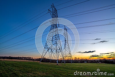 Electricity Distribution Towers and Wires at Dusk Stock Photo