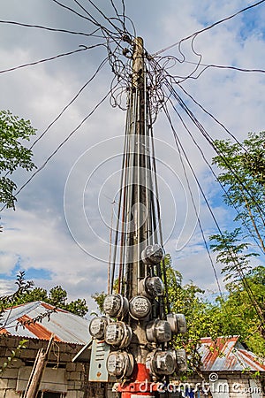 Electricity meter on a pole in Santa Juliana village, Luzon island, Philippine Stock Photo