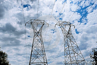 Electricity power station at a sunset. High-voltage support. clouds in the sky - scale plant danger. . electrics Stock Photo