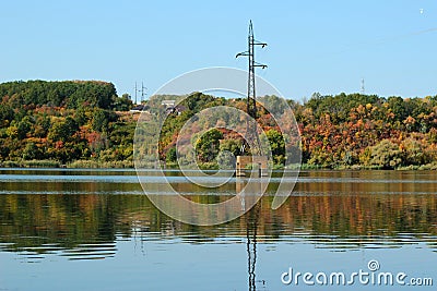 Electricity pylon stands in a lake Stock Photo