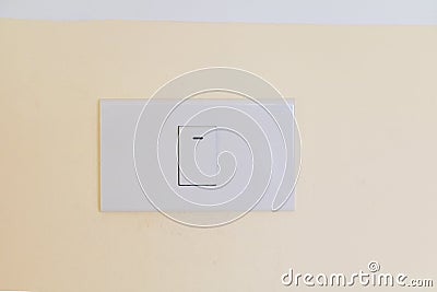Electricity switch white on wall yellow Stock Photo