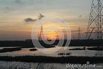 An electricity tower, power transmission tower during sunset Stock Photo