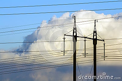 Electricity transmission power lines against white clouds. High Stock Photo