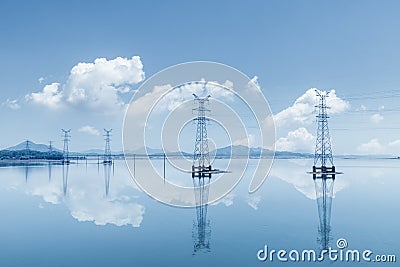 Electricity transmission pylon on lake Stock Photo