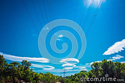 Electricity is transported by thick cables attached to metal towers Stock Photo