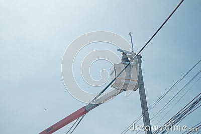 The electricity went up to the crane basket on the roadside Stock Photo