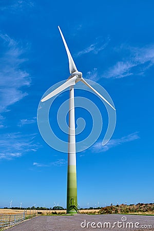 Electricity Wind turbines in a field of ripe and ready to harvest wheat Stock Photo