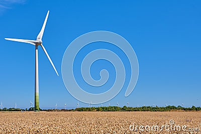 Electricity Wind turbines in a field of wheat. Stock Photo