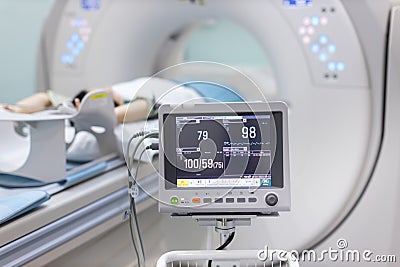 Electrocardiogram in hospital CT Scan room. heart rate monitor in hospital. Process of CT scanning of an old patient. Man Receivin Stock Photo